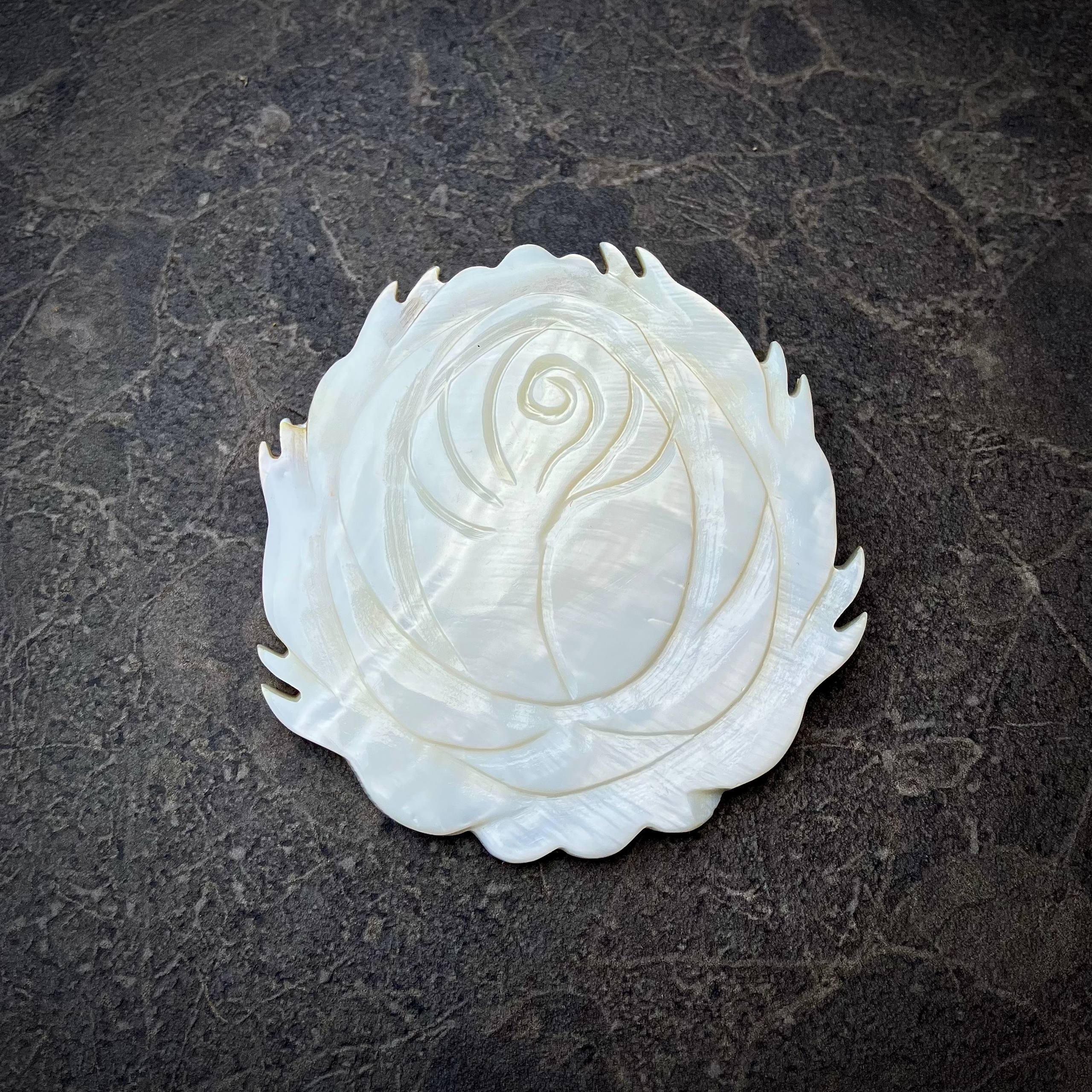 Vintage carved brooch made of natural mother of pearl